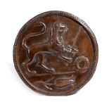 A BRONZED COPPER HERALDIC RONDEL PROBABLY ITALIAN repousse decorated with a rampant lion, holding