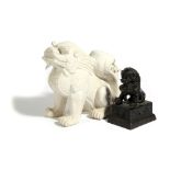 A CHINESE BRONZE MODEL OF A LION DOG 19TH CENTURY sporting a bell, seated on a rectangular plinth,