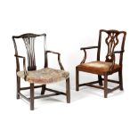 TWO GEORGE III MAHOGANY OPEN ARMCHAIRS C.1770 each with a pierced splat back and scroll arms, on