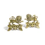 A PAIR OF BRASS LION DOORSTOPS / FIREPLACE ORNAMENTS 19TH CENTURY each modelled with a lion, on a