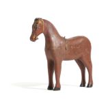 A FOLK ART CARVED AND PAINTED PINE MODEL OF A NAIVE HORSE LATE 19TH CENTURY 25.7cm high, 28cm long
