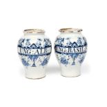 A pair of Lambeth delftware drug jars c.1730-40, the baluster forms inscribed in blue for 'Ung: