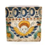 An early Italian maiolica tile c.1550-80, painted in blue, green, yellow and ochre with a putto mask