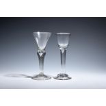 Two wine glasses c.1740-50, one with a round funnel bowl over a plain stem enclosing a single tear