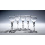 Five small wine glasses c.1760-70, a near pair with ogee bowls engraved with polished swags, two