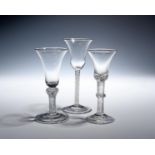 Three wine glasses c.1750-60, with bell bowls, one raised on a dense airtwist stem with vermicular