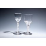 Two large wine glasses c.1760, with ogee bowls, one moulded with flutes to the base, both raised