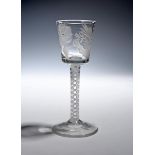 A Jacobite wine glass c.1760, the bucket bowl engraved with a rose and thistle, raised on an