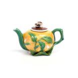A Minton Majolica teapot and cover c.1860, the body modelled as a yellow gourd applied with leafy