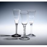 Three ale glasses c.1750-60, with elongated round funnel bowls, two moulded with vertical flutes,