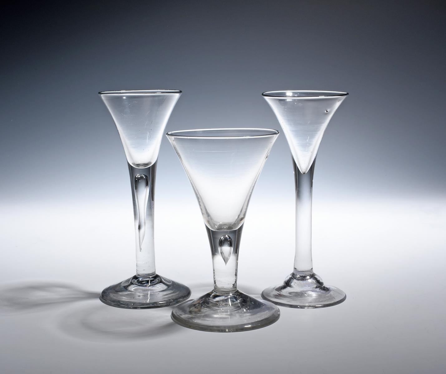 Three wine glasses c.1750-60, with drawn trumpet bowls over plain stems, two enclosing long tears,