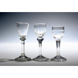 Three small wine glasses c.1730-40, one with plain round funnel bowl on a balustroid stem with
