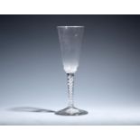 An ale glass c.1760, with slender round funnel bowl raised on a mercurial airtwist stem above a