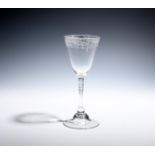 A 'Newcastle' light baluster goblet c.1740, the round funnel bowl engraved with a continuous