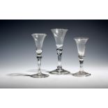 Two small gin glasses c.1730, one soda, with bell bowls over balustroid stems and folded feet, and a