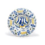 A Delft commemorative charger c.1690, the lobed form painted in blue, green and yellow with a