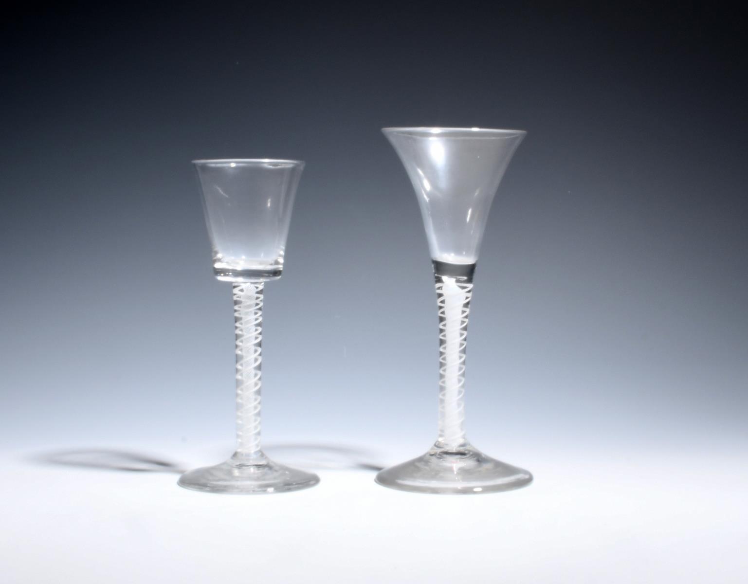 Two wine glasses c.1760, one with a drawn trumpet bowl, the other with a bucket bowl, both over