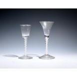 Two wine glasses c.1760, one with a drawn trumpet bowl, the other with a bucket bowl, both over