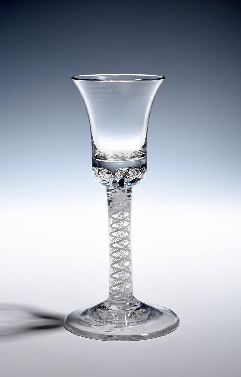 A composite stem wine glass c.1760, the bell bowl with a solid base enclosing two rows of air beads,