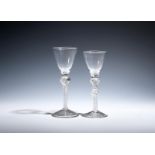 Two wine glasses c.1760, with round funnel bowls, one raised on a double-knopped airtwist stem,