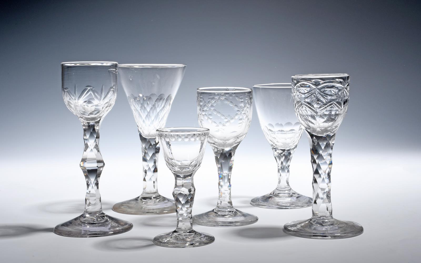 Six wine glasses c.1760-90, the bowls cut with varying designs, facets and polished ovals, raised on