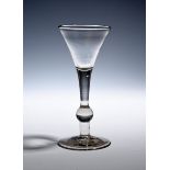 A balustroid wine glass of 'Kit Kat' type c.1740, the drawn trumpet bowl rising from a plain stem