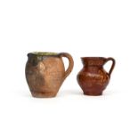 Two post medieval earthenware jugs, one c.16th century and decorated to the interior and rim with
