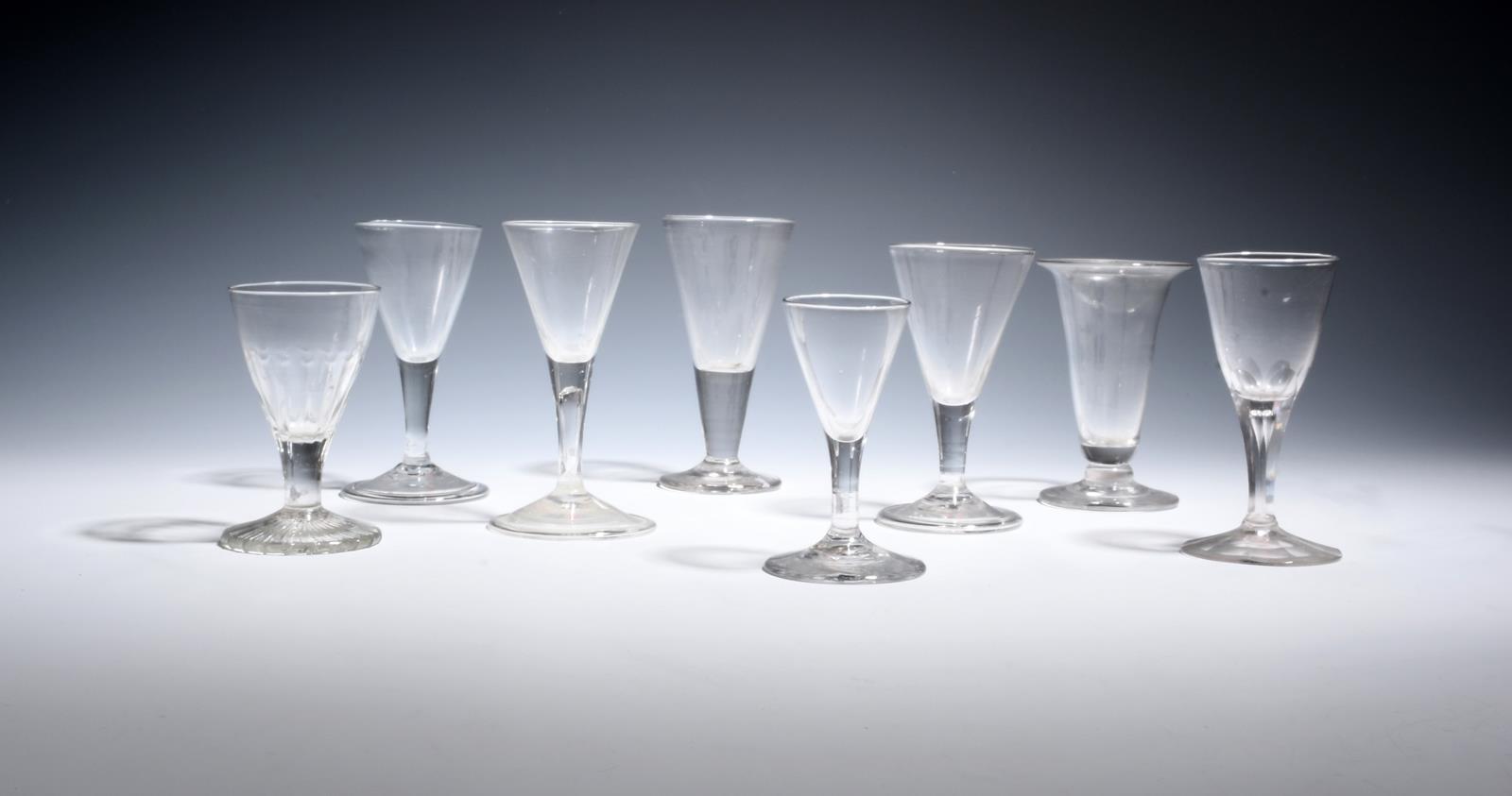 Seven small English and Continental wine glasses 18th century, with drawn trumpet bowls over plain