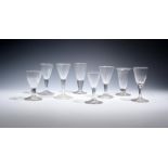 Seven small English and Continental wine glasses 18th century, with drawn trumpet bowls over plain