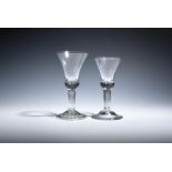 Two large wine glasses c.1730-40, with generous bell bowls raised on heavy plain stems, one on a