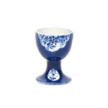 A rare Bow blue and white egg cup c.1762, painted with shaped panels of flowers and leaves and small