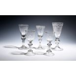 Five Dutch or Bohemian wine glasses c.1750-60, a pair engraved with inscriptions over hollow