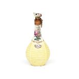 A Chelsea scent bottle c.1755, modelled as a bottle contained in a yellow wicker basket, the neck