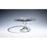 A glass baluster stem tazza c.1725, the flat circular top with a slightly flared rim, raised on a