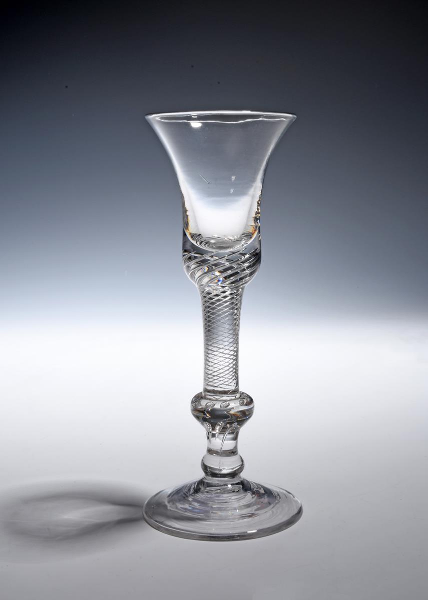 A composite stem wine glass c.1750, the bell bowl with a solid base including a dense airtwist