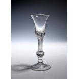 A composite stem wine glass c.1750, the bell bowl with a solid base including a dense airtwist