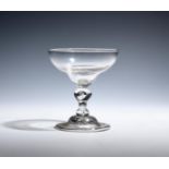 A rare champagne or mead glass c.1750, the generous ogee bowl raised from a short baluster stem