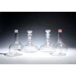 Two pairs of decanters 19th century, one pair of ship form with wide shallow bodies, the tall