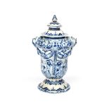 A Delft cistern and cover probably 18th century, after Adriaen Kocks, moulded with swags and two