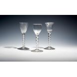 Three small wine glasses c.1760, with round funnel, bell and hammered bowls, all raised on cable