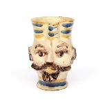 An Italian maiolica mask jar late 18th century, Caltagirone, modelled as the face of a Moor with