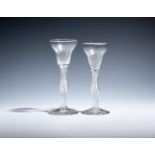 A near pair of small wine glasses c.1760, with pan-topped bowls raised on airtwist stems with a