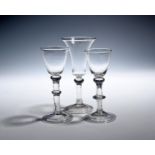 Three balustroid wine glasses c.1740-50, two with round funnel bowls over stems with shoulder and