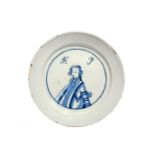 A rare English delftware King of Prussia plate c.1757-60, painted in blue with a head and