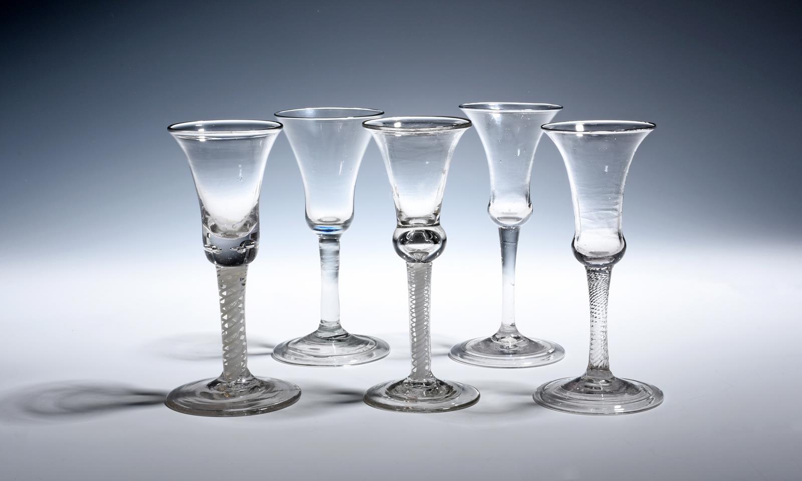 Five Continental wine glasses mid 18th century, with bell bowls, two raised on plain stems, one on