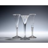 Two wine flutes c.1760, the slender drawn trumpet bowls with everted rims, raised on double series