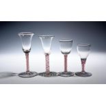 Four Dutch colour-twist wine glasses c.1760, two with bell bowls and two with round funnel bowls,