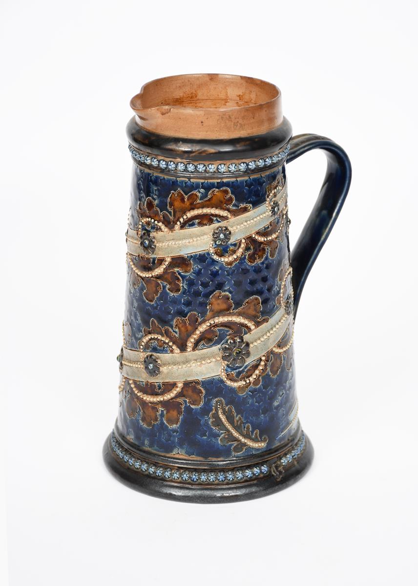 A Doulton Lambeth stoneware jug probably by George Tinworth, tapering cylindrical form, incised with