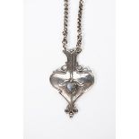 An Edgar Gilstrap Simpson Arts and Crafts silver and moonstone pendant necklace, shield-shaped,