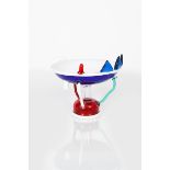 A Memphis Milano Sol glass bowl designed by Ettore Sottsass, designed 1982, blue glass bowl on clear